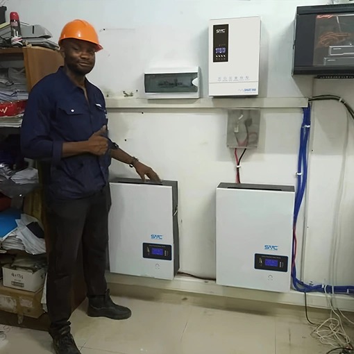 Tall, white, sleek solar energy storage battery module unit featuring the SVC energy blue logo in black environmental room